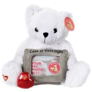 White teddy bear holding photo slot and heart